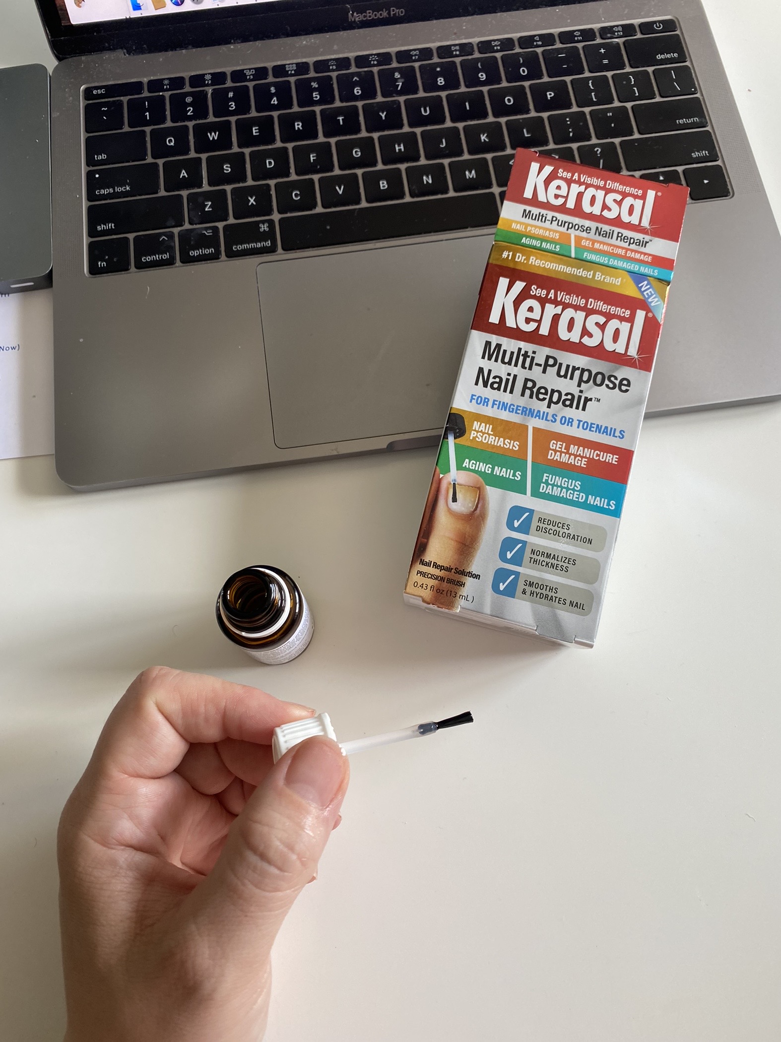 Springtime Products by popular Ohio life and style blog, Coffee Beans and Bobby Pins: image of a woman holding Kerasal multi-purpose nail repair. 