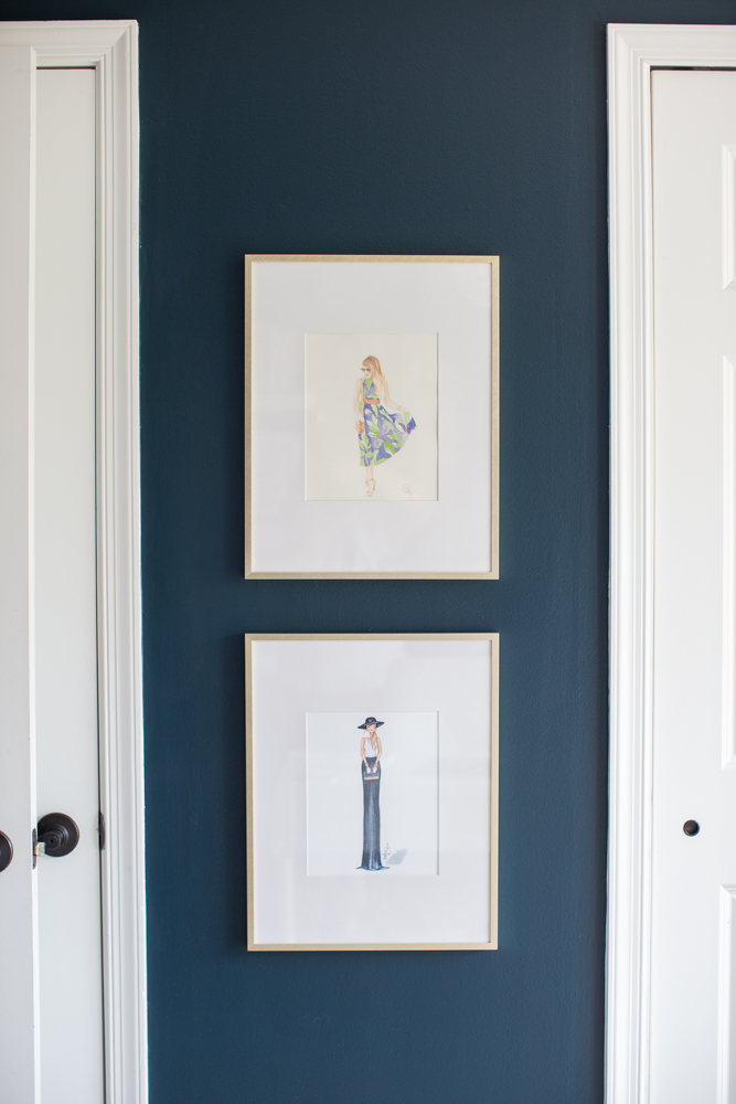 Office Revamp by popular Ohio life and style blog, Coffee Beans and Bobby Pins: image of watercolor prints in gold frames hanging on a navy blue painted wall. 